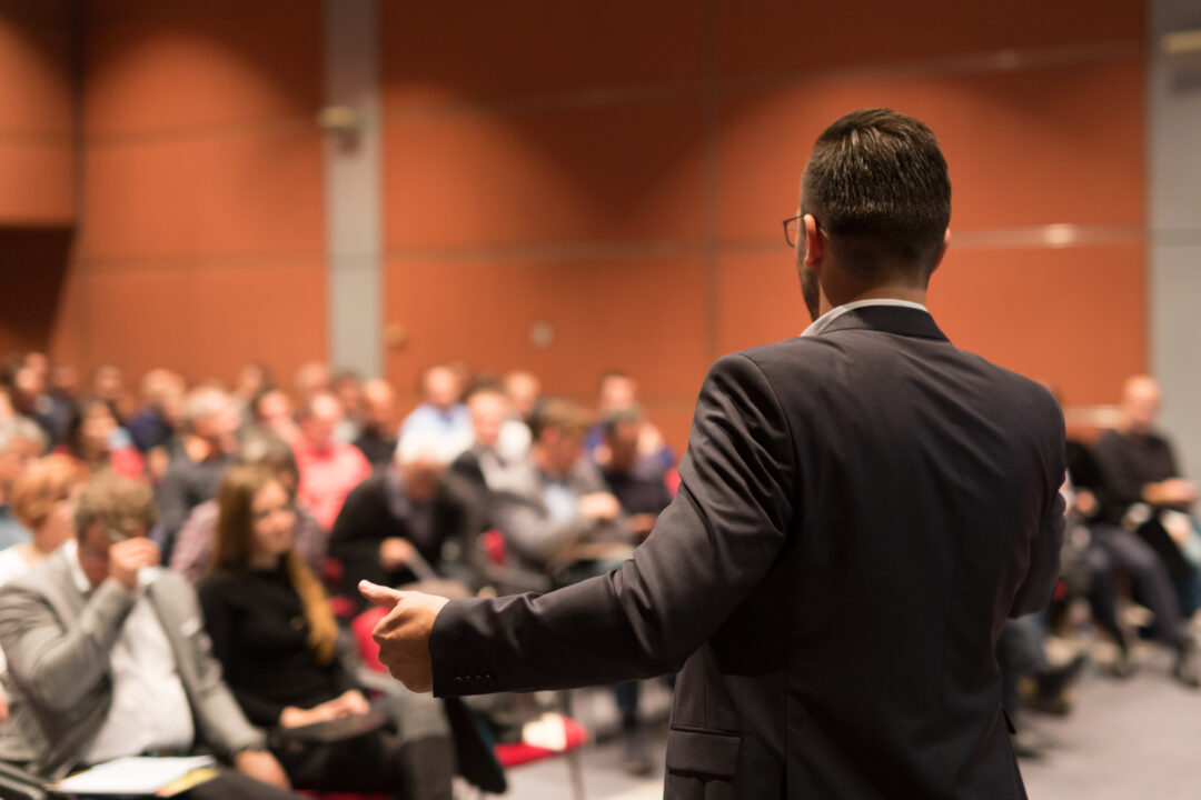 Speaker giving a talk to audience at the conference hall
