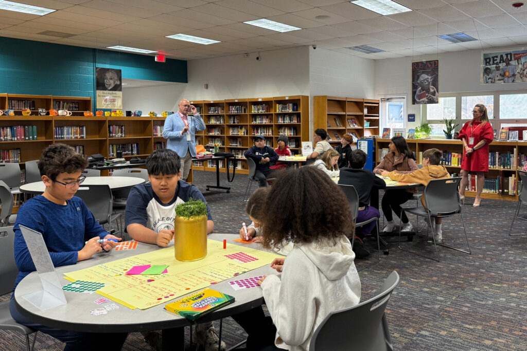 John with students in the library